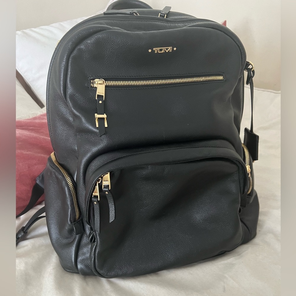 Black leather TUMI backpack with gold hardware
